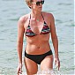 CharlizeTheron_wearingabikiniatabeachinHawaii_003.jpg