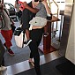 CharlizeandhersonJacksondepartingonflightatLAX_03.jpg