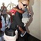 CharlizeandhersonJacksondepartingonflightatLAX_06.jpg